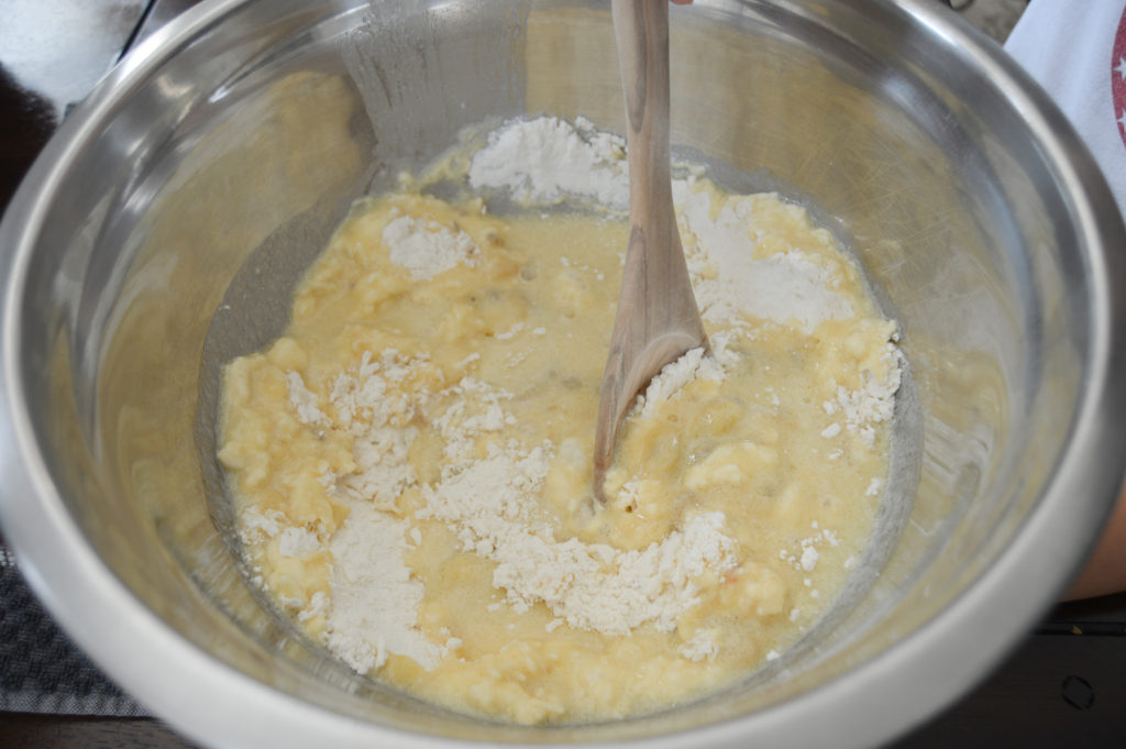 To show the mixing for the dry and wet ingredients on how to make banana bread.