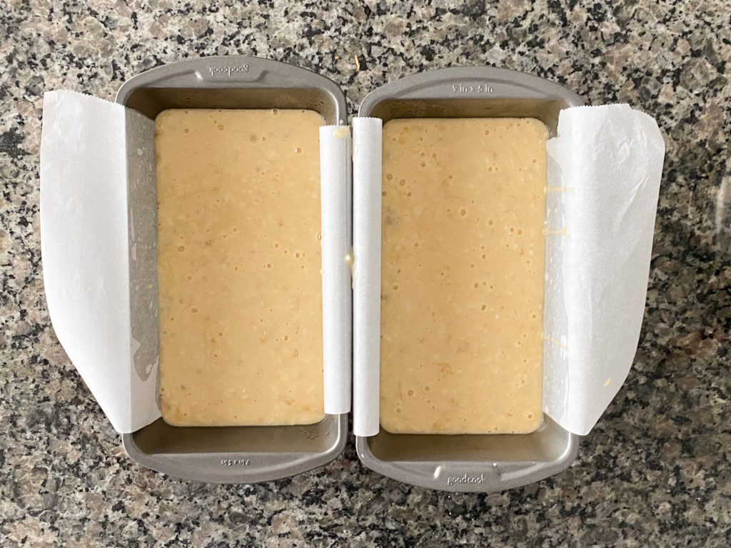 To show two bread pan filled with the banana bread batter.