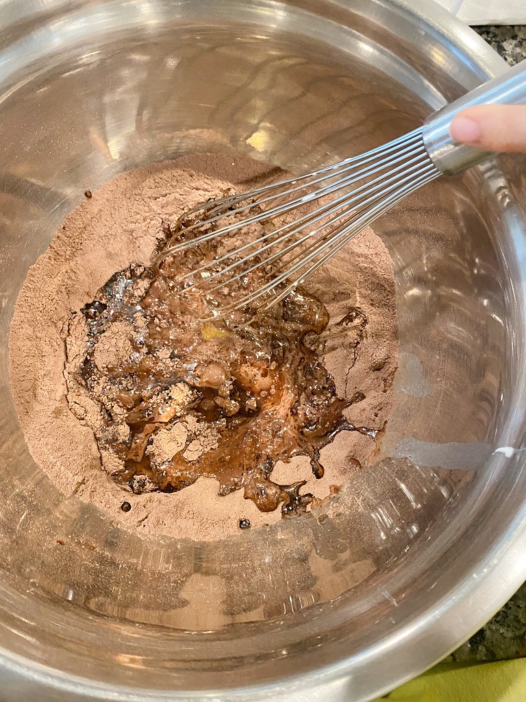 Mixing wet and dry ingredients chocolate cupcake. 