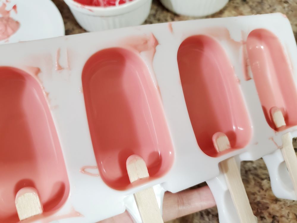 Adding chocolate to cakesicles molds